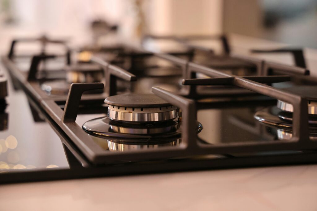 Close-up of a modern stainless steel gas stove top, ideal for contemporary kitchens and cooking environments.